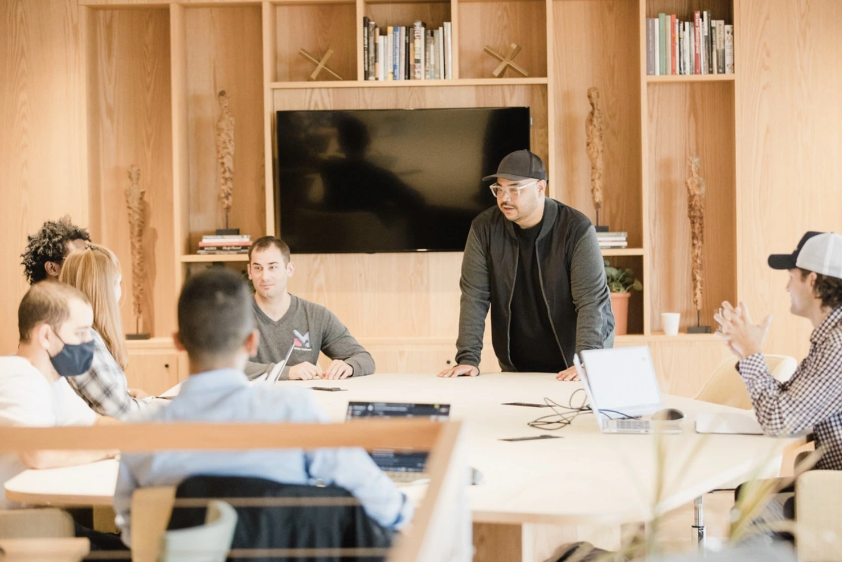 Erik and Justin leading a team meeting in a modern conference room.